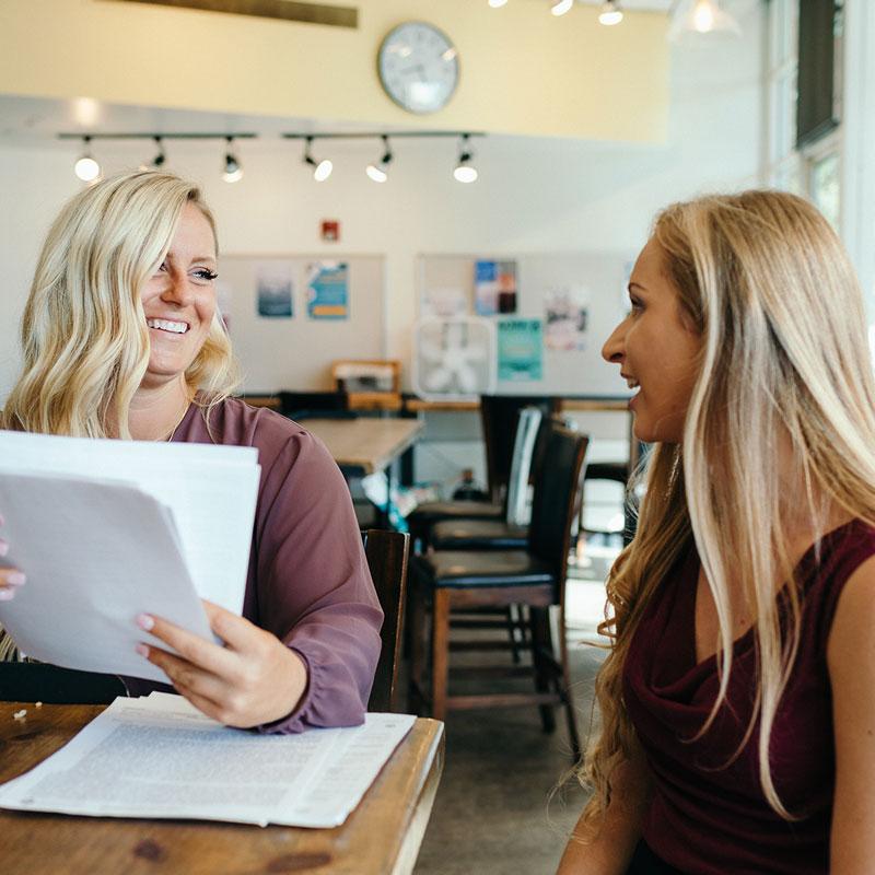 Two females reviewing paperwork